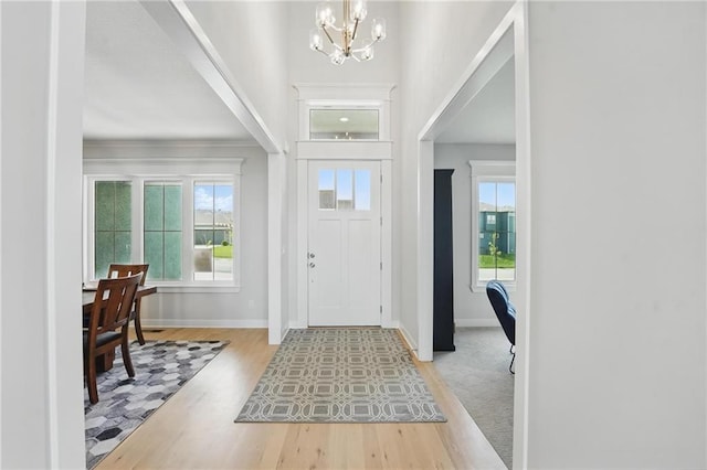 1312 NW 107th Ter, Kansas City, MO 64155 - entrance foyer with a chandelier, wood finished floors, baseboards, and crown molding
