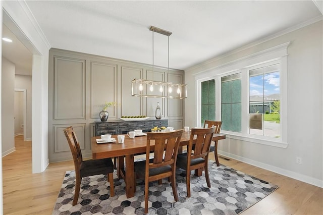 1312 NW 107th Ter, Kansas City, MO 64155 - dining area featuring light wood-style floors, ornamental molding, and baseboards