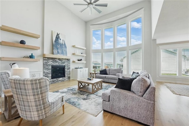 1312 NW 107th Ter, Kansas City, MO 64155 - living room with high vaulted ceiling, ceiling fan, wood finished floors, and a fireplace