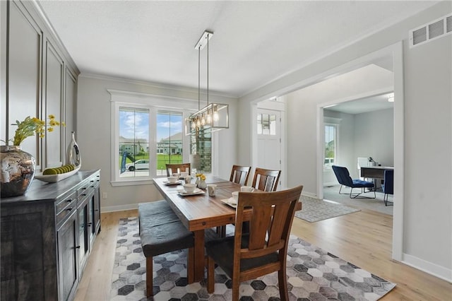 1312 NW 107th Ter, Kansas City, MO 64155 - dining area with light wood-style floors, crown molding, baseboards, an office area, and a chandelier
