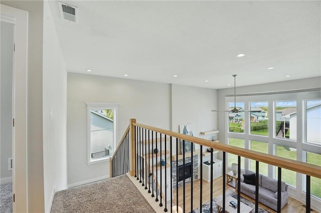 1312 NW 107th Ter, Kansas City, MO 64155 - hallway featuring plenty of natural light, an upstairs landing, baseboards, and recessed lighting