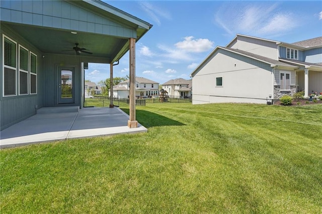 1312 NW 107th Ter, Kansas City, MO 64155 - view of yard featuring ceiling fan, a patio, and a residential view