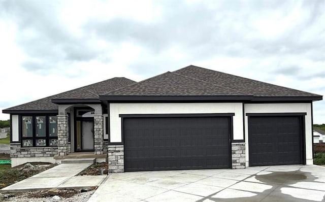 2319 SW Serena Pl, Lees Summit, MO 64082 - prairie-style house featuring an attached garage, stone siding, a shingled roof, and driveway