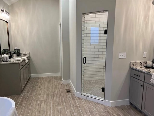 2319 SW Serena Pl, Lees Summit, MO 64082 - full bathroom with a stall shower, wood finish floors, vanity, and baseboards