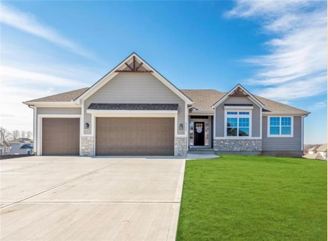 2303 SW Serena Pl, Lees Summit, MO 64082 - craftsman inspired home featuring a garage, a front yard, driveway, and stone siding