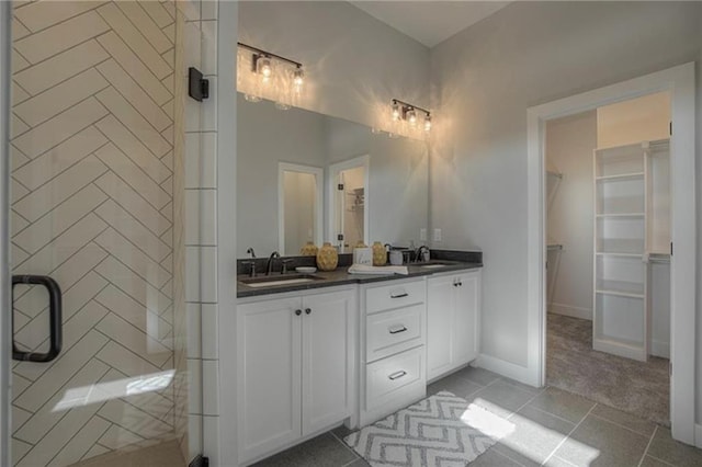 2303 SW Serena Pl, Lees Summit, MO 64082 - bathroom featuring a spacious closet, double vanity, and tile patterned floors