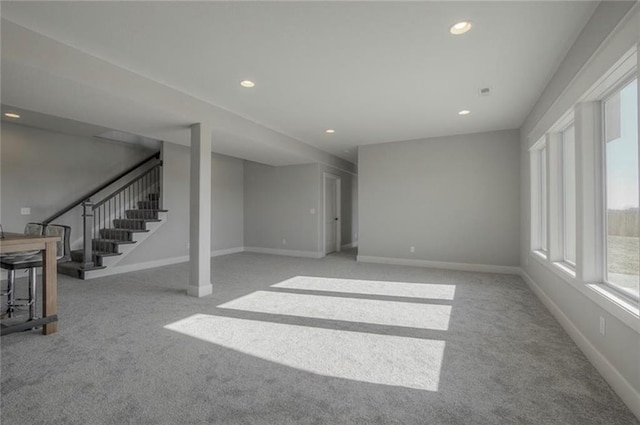2303 SW Serena Pl, Lees Summit, MO 64082 - unfurnished living room with carpet flooring, recessed lighting, stairs, and baseboards