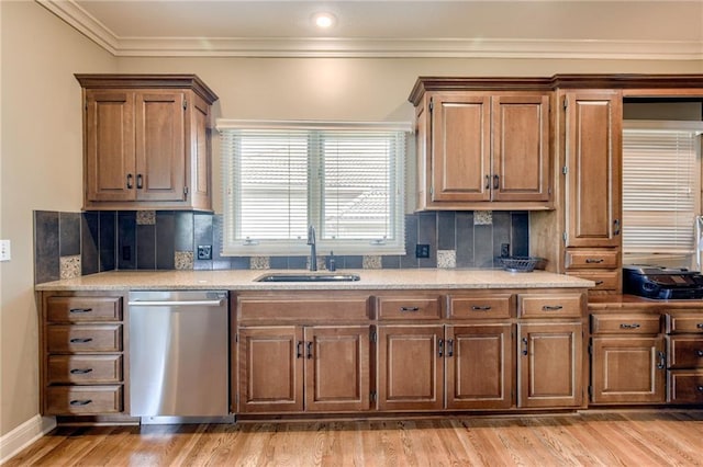 kitchen featuring a sink, light countertops, decorative backsplash, and dishwasher