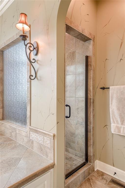 full bathroom featuring visible vents and a shower stall