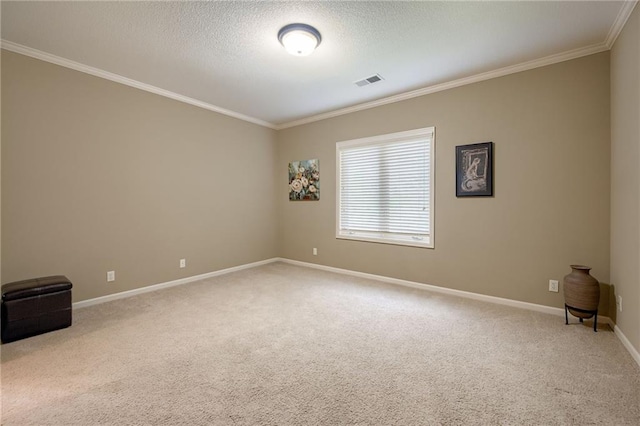 carpeted spare room featuring crown molding, a textured ceiling, baseboards, and visible vents