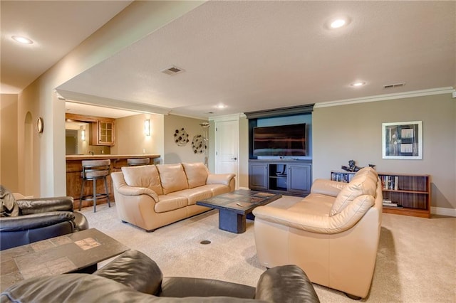 carpeted living room featuring recessed lighting, visible vents, and ornamental molding