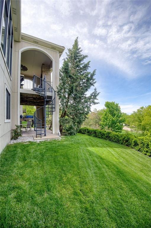 view of yard with a patio and stairway