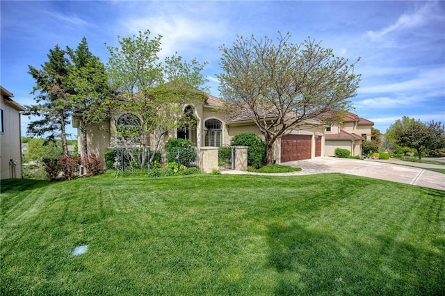 mediterranean / spanish home with an attached garage, driveway, a front yard, and stucco siding