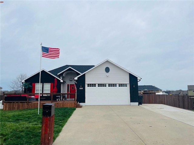 ranch-style home with an attached garage, a front lawn, fence, and concrete driveway