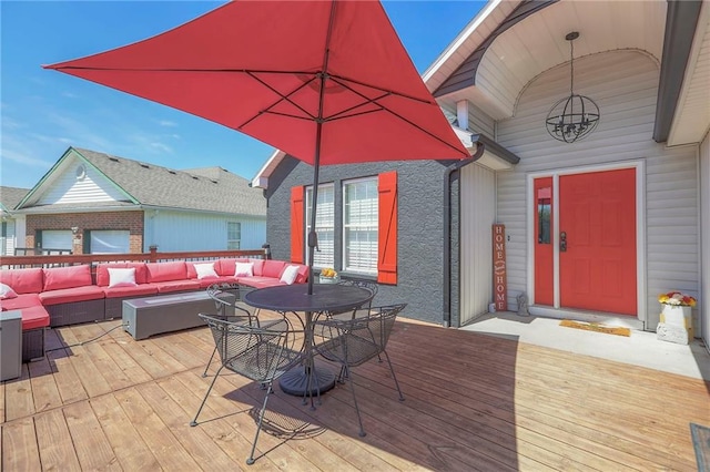 wooden deck featuring outdoor lounge area and outdoor dining space