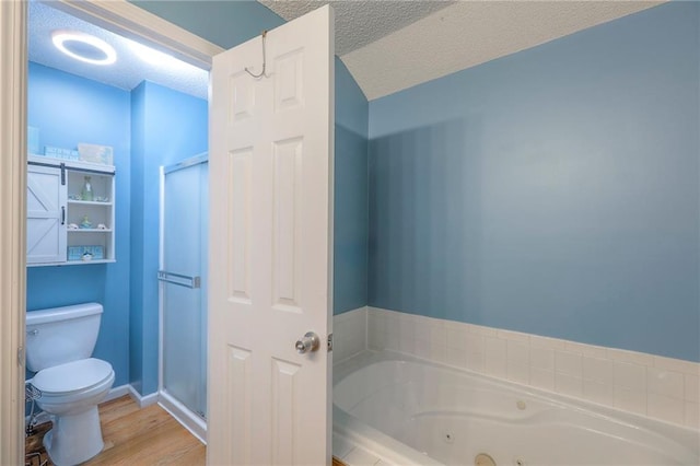 bathroom with a jetted tub, a textured ceiling, toilet, and a shower stall