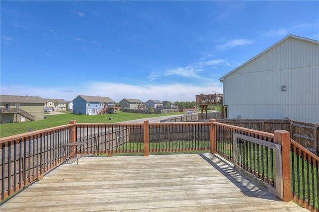 wooden deck with a fenced backyard, a yard, and a residential view