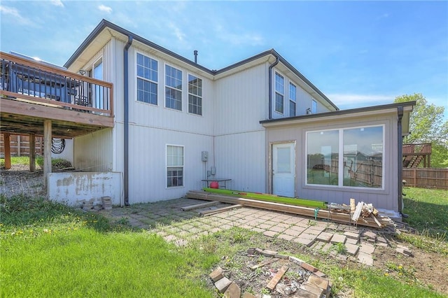 back of house featuring a deck and fence