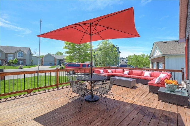 wooden deck featuring a lawn, outdoor lounge area, and a residential view