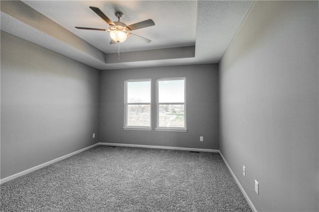 6022 NE 118th Ter, Kansas City, MO 64156 - carpeted empty room featuring a tray ceiling, ceiling fan, and baseboards