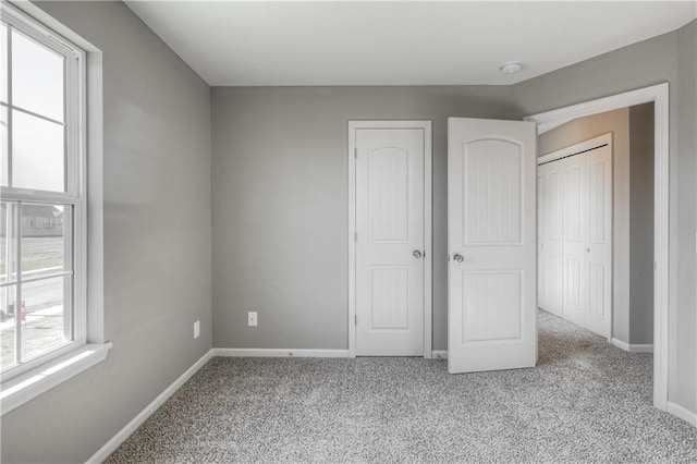 6022 NE 118th Ter, Kansas City, MO 64156 - unfurnished bedroom with baseboards and carpet flooring