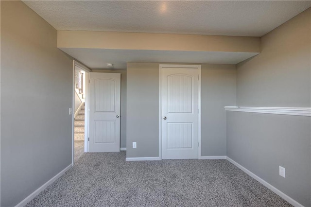 6022 NE 118th Ter, Kansas City, MO 64156 - carpeted spare room with stairs, a textured ceiling, and baseboards