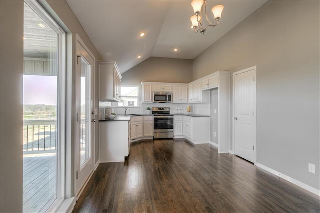 6022 NE 118th Ter, Kansas City, MO 64156 - kitchen featuring a sink, stainless steel appliances, vaulted ceiling, dark wood-style flooring, and white cabinets