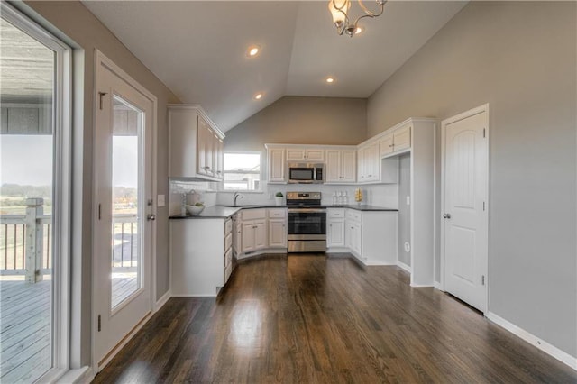 6022 NE 118th Ter, Kansas City, MO 64156 - kitchen with lofted ceiling, a sink, white cabinetry, dark wood-type flooring, and stainless steel appliances