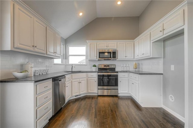 6022 NE 118th Ter, Kansas City, MO 64156 - kitchen with backsplash, dark countertops, appliances with stainless steel finishes, and a sink