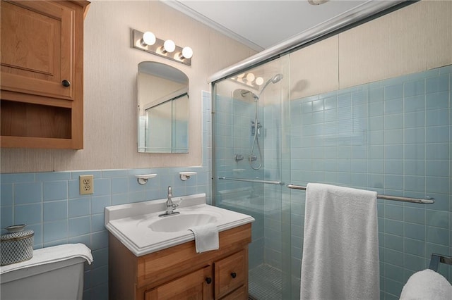 full bathroom featuring toilet, tile walls, a stall shower, vanity, and crown molding