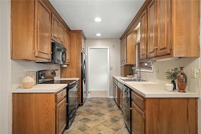 kitchen featuring black appliances, a sink, recessed lighting, brown cabinets, and light countertops