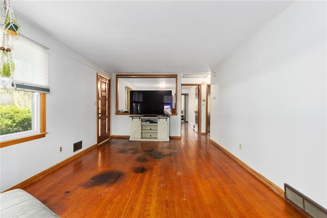 9382 N Cookingham Dr, Kansas City, MO 64157 - unfurnished living room with baseboards, wood finished floors, and visible vents