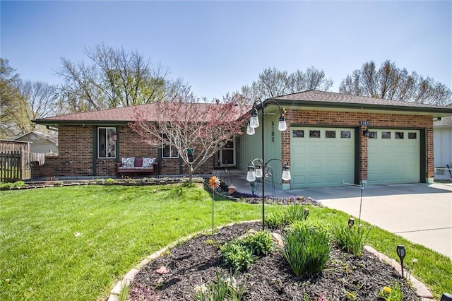 5103 S Shrank Ave, Independence, MO 64055 - ranch-style home featuring a garage, brick siding, fence, a front lawn, and concrete driveway