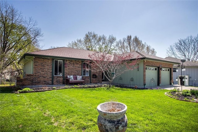 5103 S Shrank Ave, Independence, MO 64055 - ranch-style house with brick siding, a garage, a front lawn, and driveway