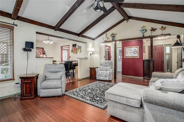 5103 S Shrank Ave, Independence, MO 64055 - living area featuring baseboards, lofted ceiling with beams, ceiling fan with notable chandelier, and wood finished floors