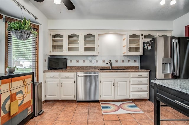 5103 S Shrank Ave, Independence, MO 64055 - kitchen with a sink, decorative backsplash, a ceiling fan, and stainless steel appliances