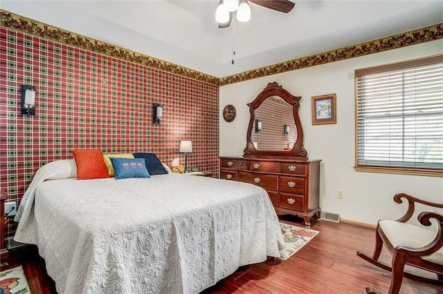 5103 S Shrank Ave, Independence, MO 64055 - bedroom with a ceiling fan, baseboards, visible vents, and wood finished floors