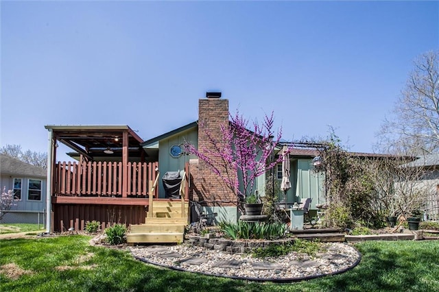 5103 S Shrank Ave, Independence, MO 64055 - back of house with a chimney, a yard, and a deck