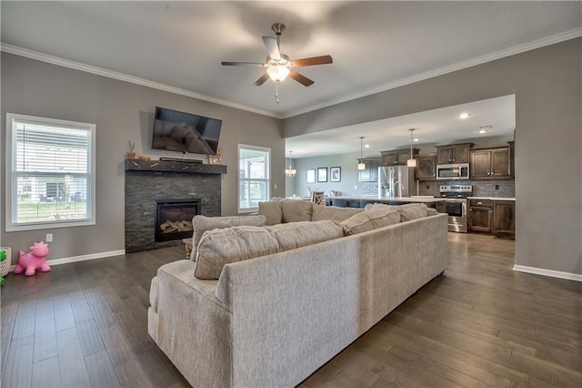 4246 Lakeview Ter, Basehor, KS 66007 - living room featuring baseboards, a wealth of natural light, a ceiling fan, and dark wood-style floors