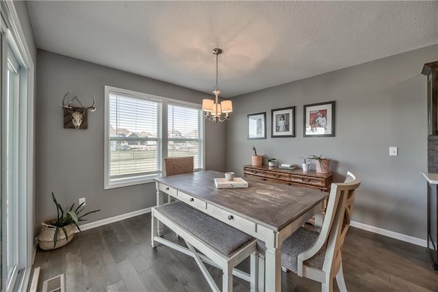 4246 Lakeview Ter, Basehor, KS 66007 - dining space featuring dark wood-style floors, baseboards, and an inviting chandelier