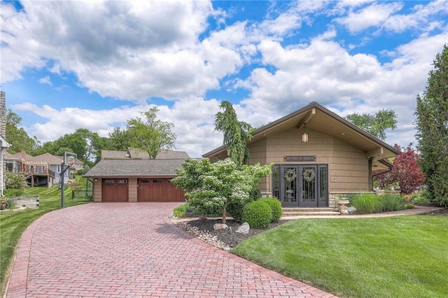 101 Algonquin Dr, Lake Winnebago, MO 64034 - view of front facade featuring french doors, a front yard, and decorative driveway