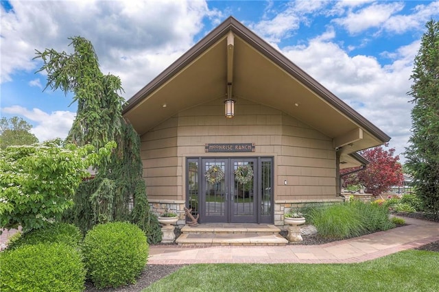 101 Algonquin Dr, Lake Winnebago, MO 64034 - entrance to property featuring french doors and stone siding