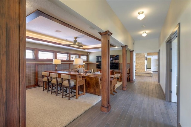 101 Algonquin Dr, Lake Winnebago, MO 64034 - kitchen with wood finished floors, ceiling fan, a raised ceiling, and ornate columns