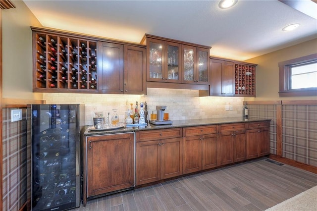 101 Algonquin Dr, Lake Winnebago, MO 64034 - bar area featuring beverage cooler, dark wood-style flooring, backsplash, and recessed lighting