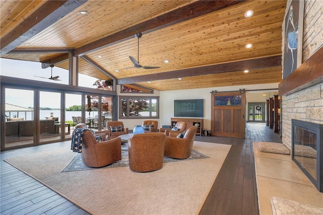101 Algonquin Dr, Lake Winnebago, MO 64034 - living area with a ceiling fan, a stone fireplace, a barn door, wood-type flooring, and recessed lighting
