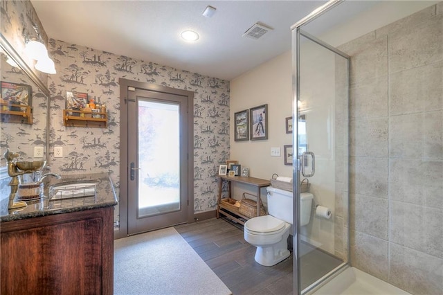 101 Algonquin Dr, Lake Winnebago, MO 64034 - bathroom featuring wallpapered walls, vanity, toilet, a shower stall, and wood finished floors