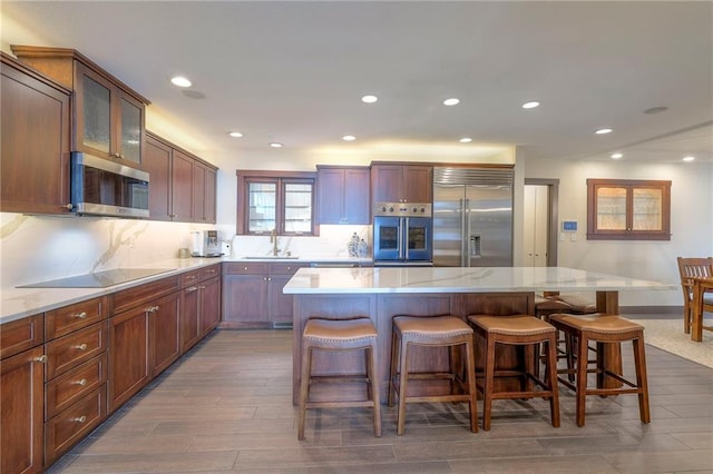 101 Algonquin Dr, Lake Winnebago, MO 64034 - kitchen with stainless steel appliances, a sink, recessed lighting, a kitchen bar, and a center island