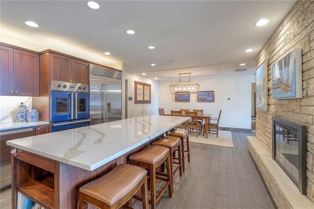 101 Algonquin Dr, Lake Winnebago, MO 64034 - kitchen featuring stainless steel appliances, dark wood finished floors, a center island, recessed lighting, and baseboards