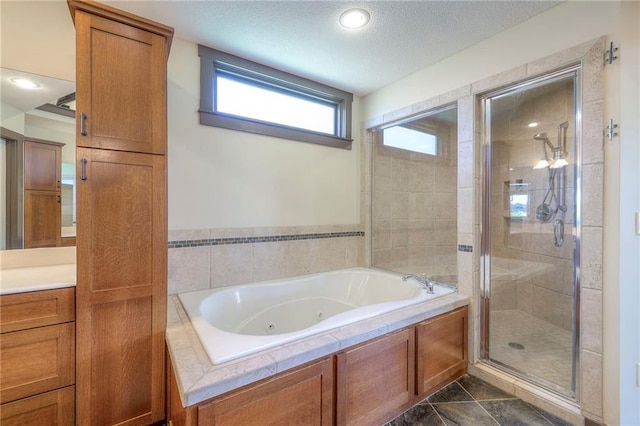 101 Algonquin Dr, Lake Winnebago, MO 64034 - bathroom with a tub with jets, a stall shower, vanity, and recessed lighting