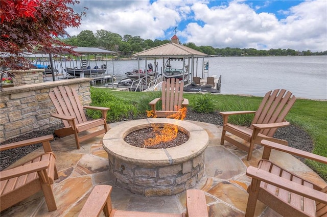 101 Algonquin Dr, Lake Winnebago, MO 64034 - view of patio featuring an outdoor fire pit, boat lift, a boat dock, and a water view